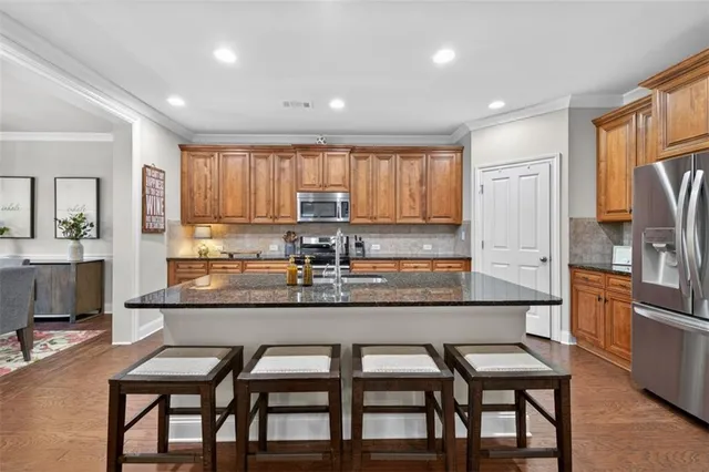 a kitchen with granite countertop counter top space a sink appliances and cabinets