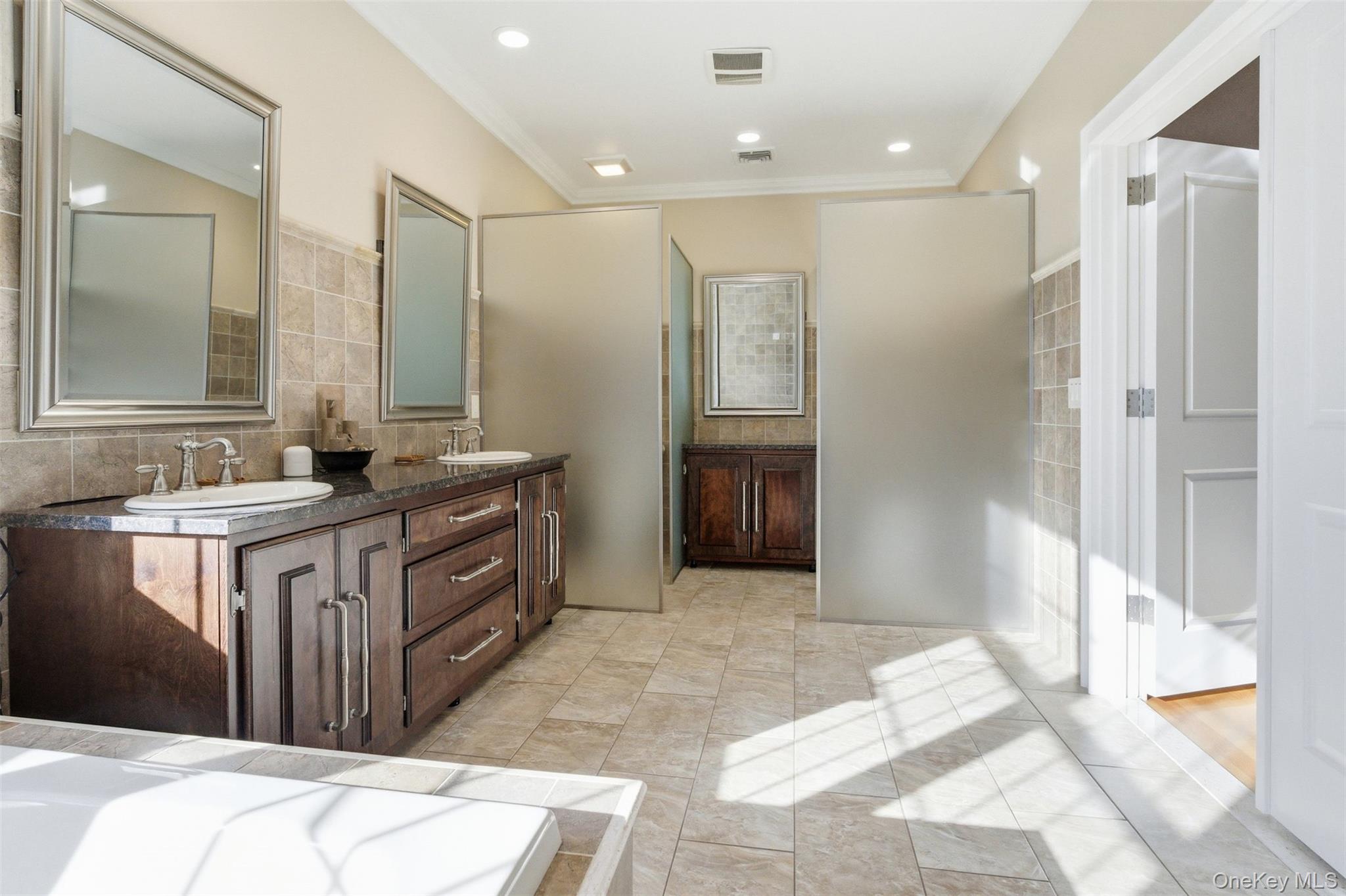 33 A Newtown Road Hampton Bays, NY 11946 - Photo 40 of 50 Bathroom featuring double vanity, backsplash, and crown molding