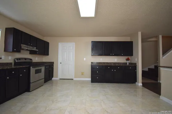 a large kitchen with cabinets and stainless steel appliances
