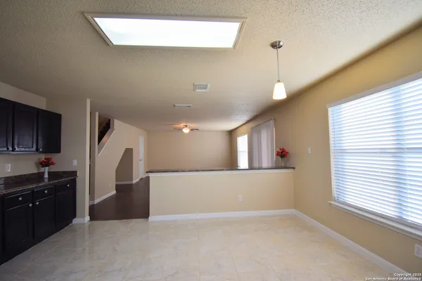 a view of a kitchen with a stove wooden floor and a kitchen