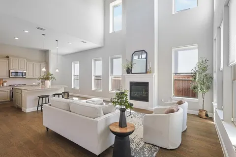 a living room with fireplace furniture and a large window
