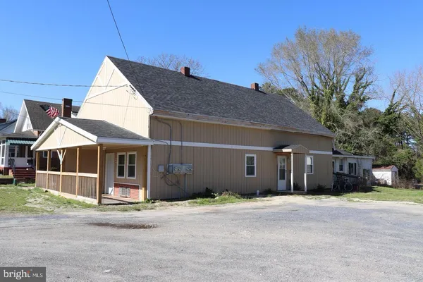 a front view of a house with a garden and garage