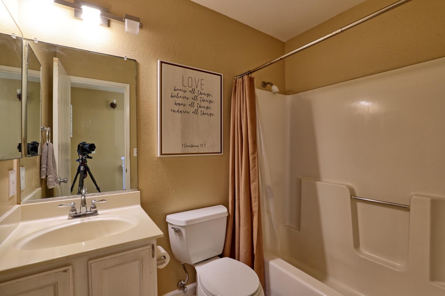 801 Nash Road, Unit I2 Hollister, CA 95023 - Photo 11 of 26 a bathroom with a granite countertop sink toilet and shower