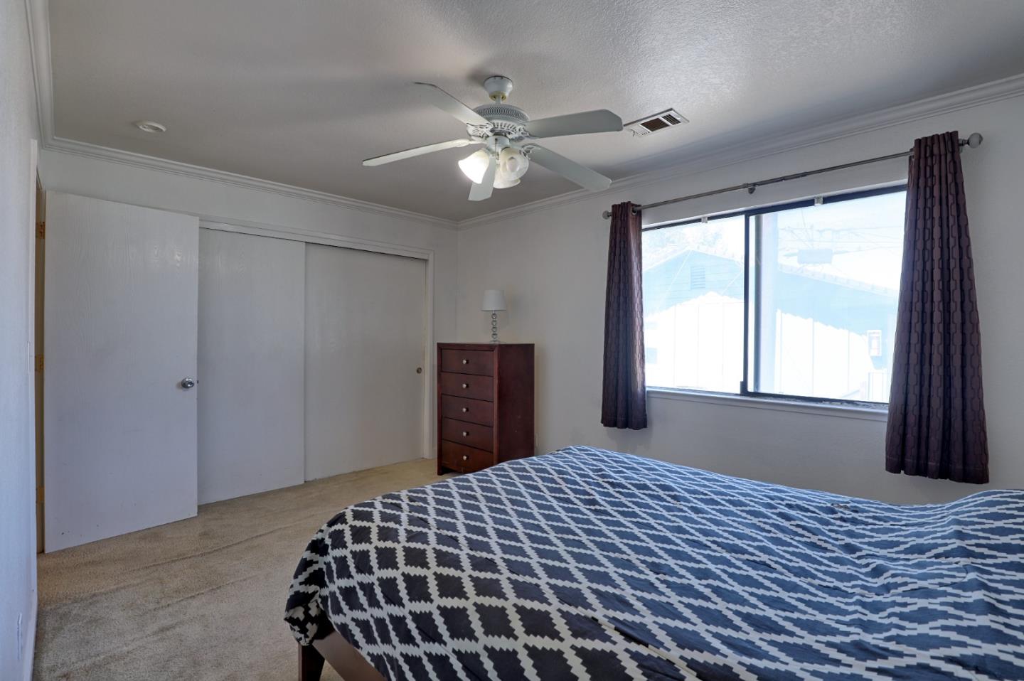 801 Nash Road, Unit I2 Hollister, CA 95023 - Photo 13 of 26 a bedroom with a bed and a window