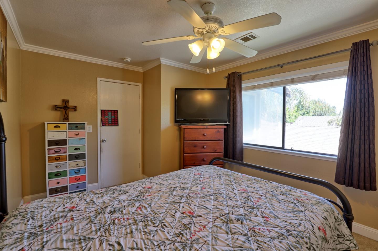801 Nash Road, Unit I2 Hollister, CA 95023 - Photo 20 of 26 a bedroom with furniture and a flat screen tv