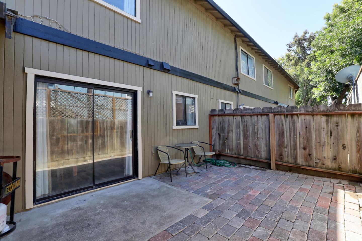 801 Nash Road, Unit I2 Hollister, CA 95023 - Photo 22 of 26 a view of a backyard with wooden floor and iron fence