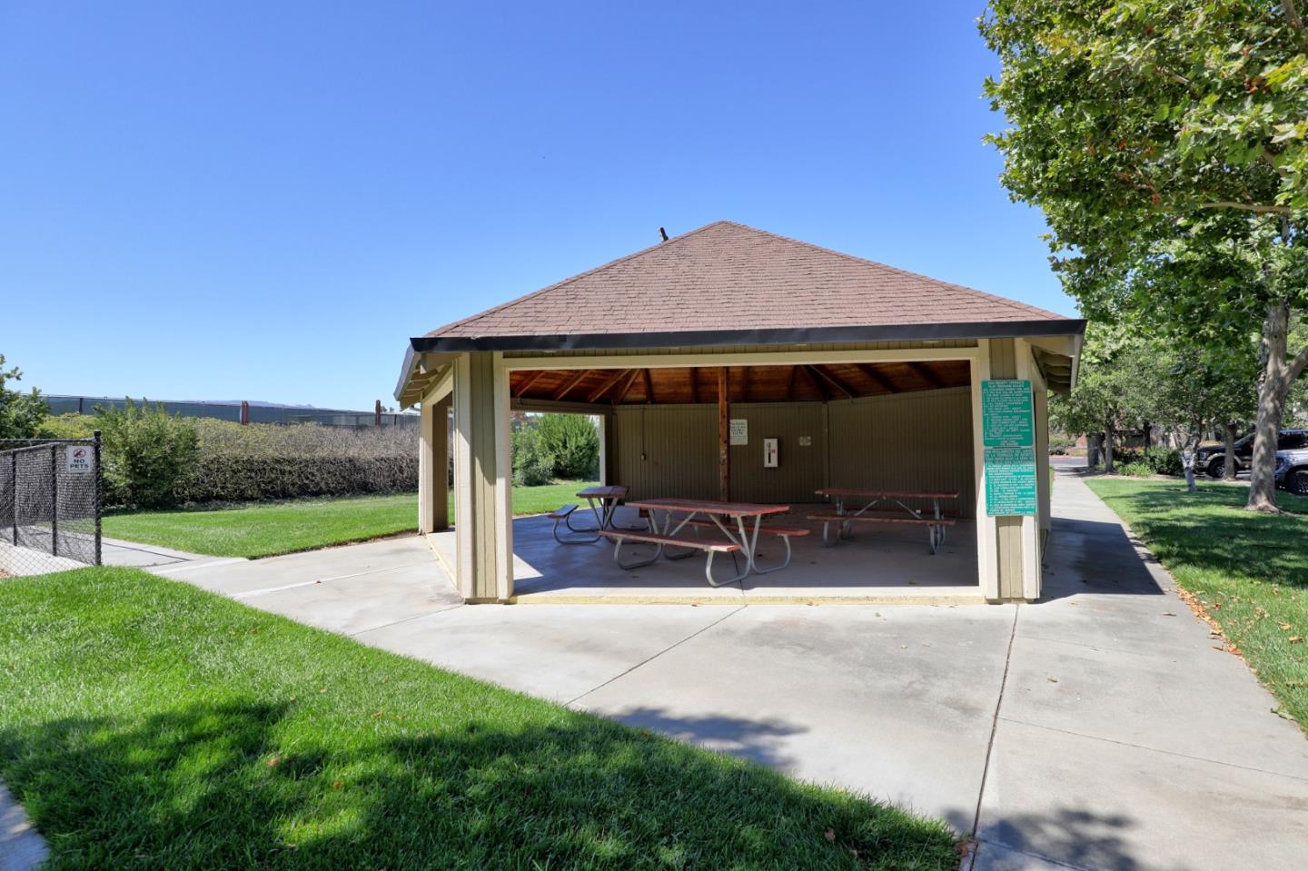 801 Nash Road, Unit I2 Hollister, CA 95023 - Photo 24 of 26 a view of a patio with a table and chairs under an umbrella