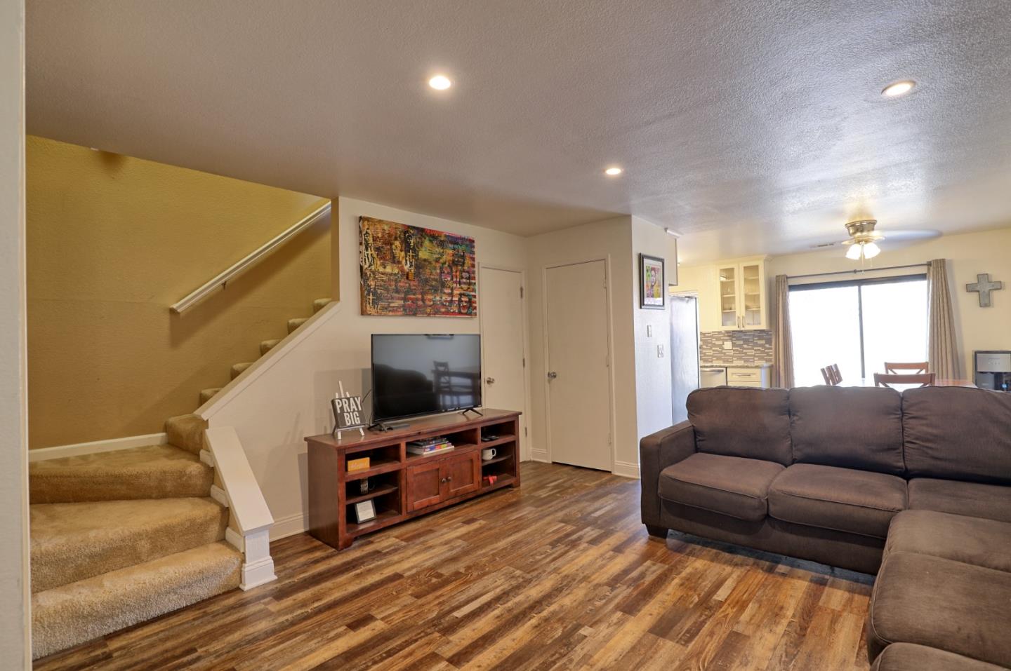 801 Nash Road, Unit I2 Hollister, CA 95023 - Photo 3 of 26 a living room with furniture and a flat screen tv
