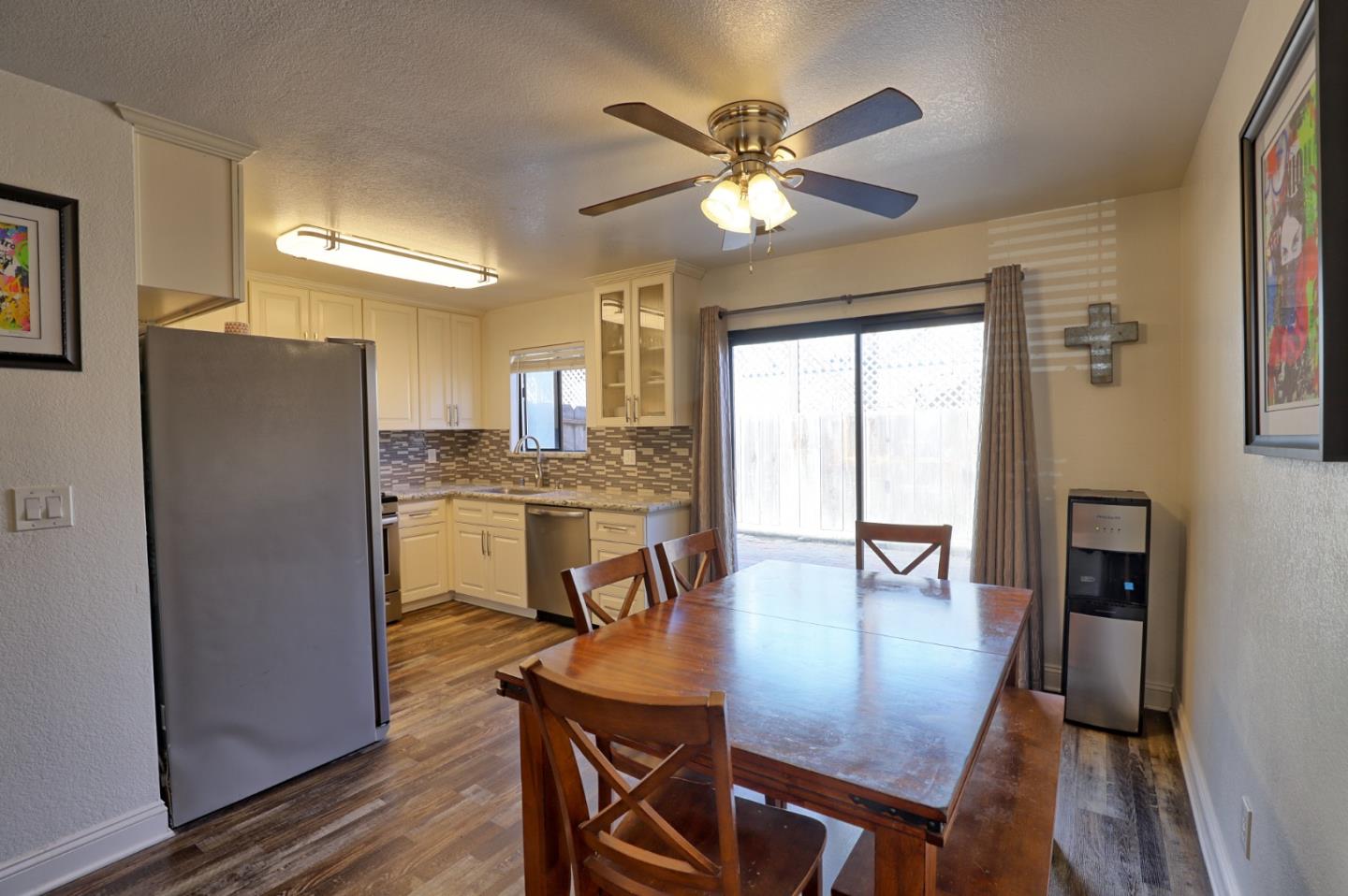 801 Nash Road, Unit I2 Hollister, CA 95023 - Photo 6 of 26 a view of a dining room with furniture window and wooden floor