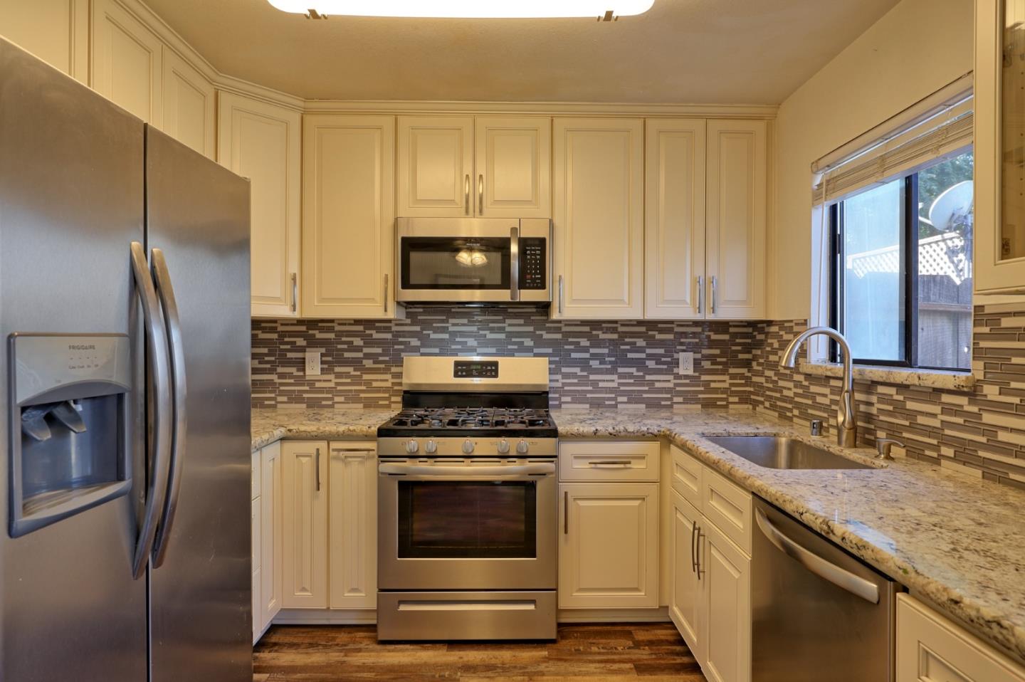801 Nash Road, Unit I2 Hollister, CA 95023 - Photo 7 of 26 a kitchen with a stove microwave and refrigerator