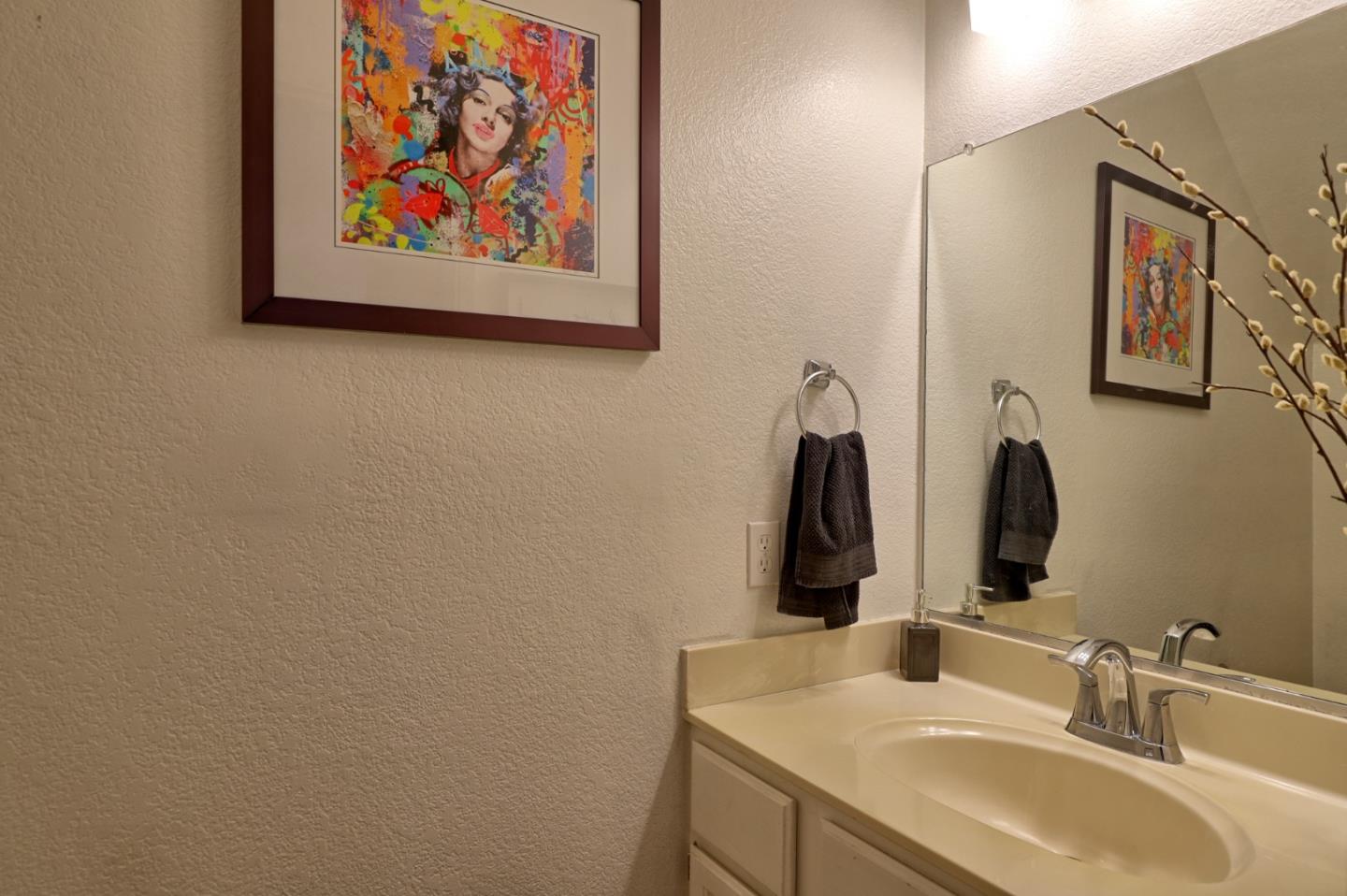 801 Nash Road, Unit I2 Hollister, CA 95023 - Photo 9 of 26 a bathroom with a sink and a mirror