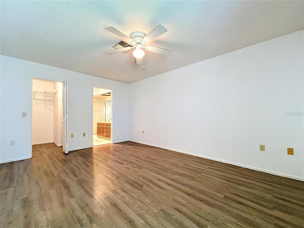 9319 Trowbridge Court New Port Richey, FL 34655 - Photo 42 of 78 a view of an empty room with wooden floor and a window