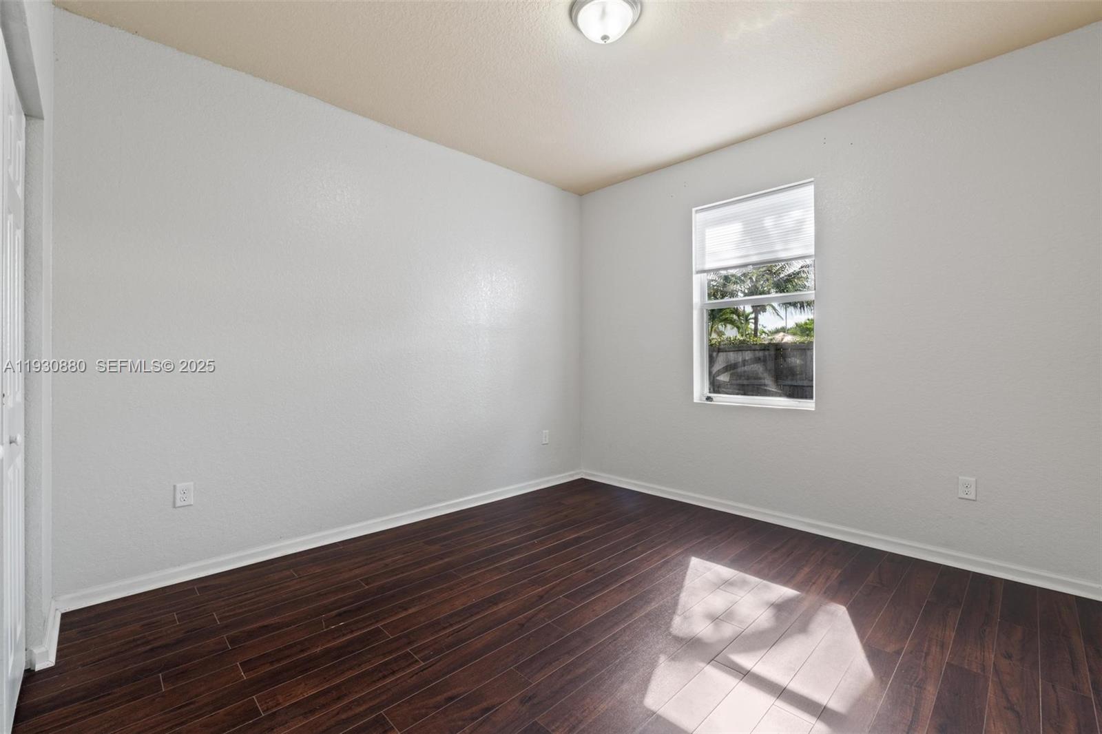 3448 Northeast 1st Street, Unit 3448 Homestead, FL 33033 - Photo 13 of 19 an empty room with wooden floor and windows