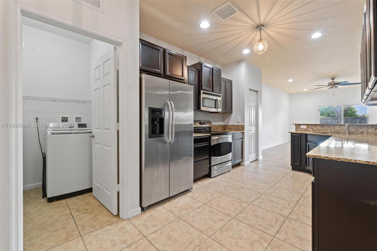 3448 Northeast 1st Street, Unit 3448 Homestead, FL 33033 - Photo 5 of 19 a kitchen with stainless steel appliances granite countertop a refrigerator and a sink