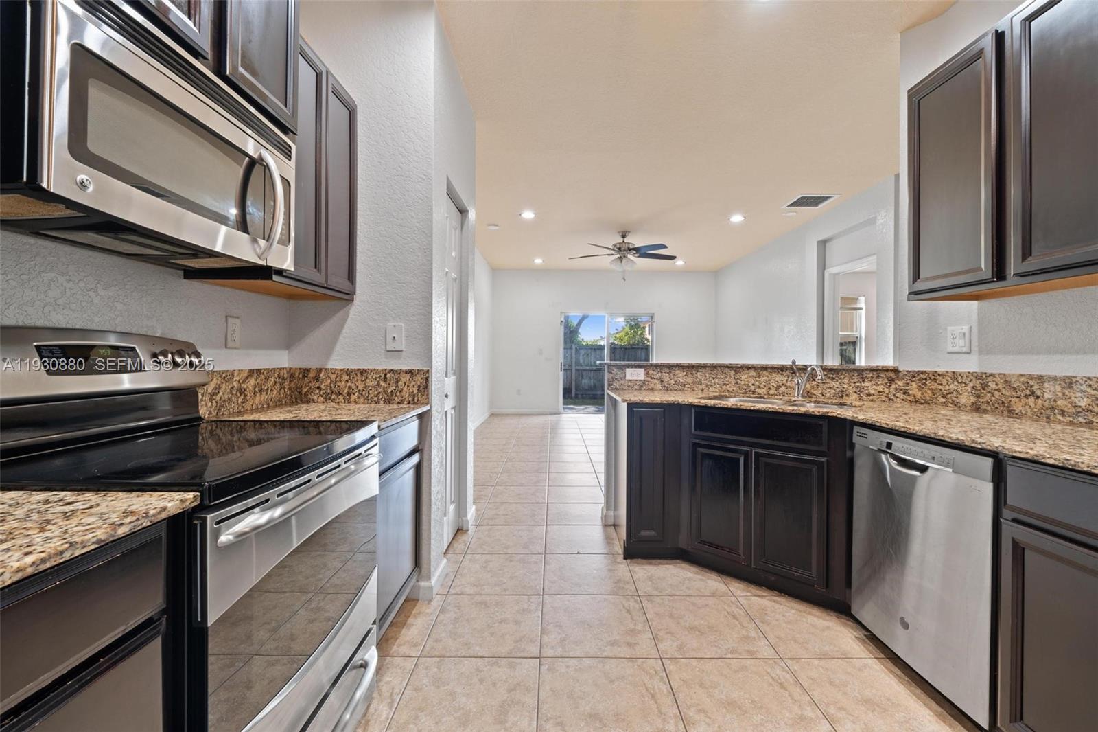 3448 Northeast 1st Street, Unit 3448 Homestead, FL 33033 - Photo 7 of 19 a kitchen with stainless steel appliances granite countertop a stove and a sink