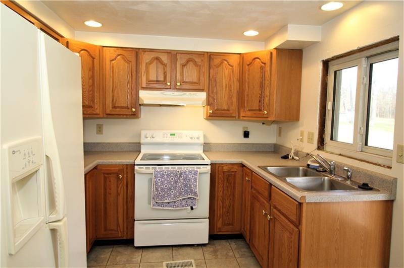 247 Van Meter Road Smithton, PA 15479 - Photo 2 of 16 Updated recessed lighting in the kitchen make it a great space to prepare your favorite meals. The window over the sink gives a great view of the backyard.