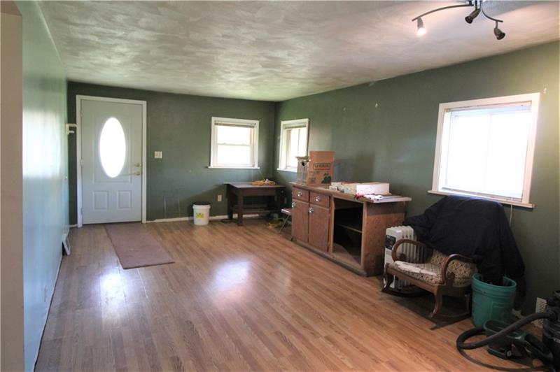 247 Van Meter Road Smithton, PA 15479 - Photo 7 of 16 Huge 21x12 Living Room has lots of space for entertaining! Lots of windows mean plenty of natural light flows through the space.