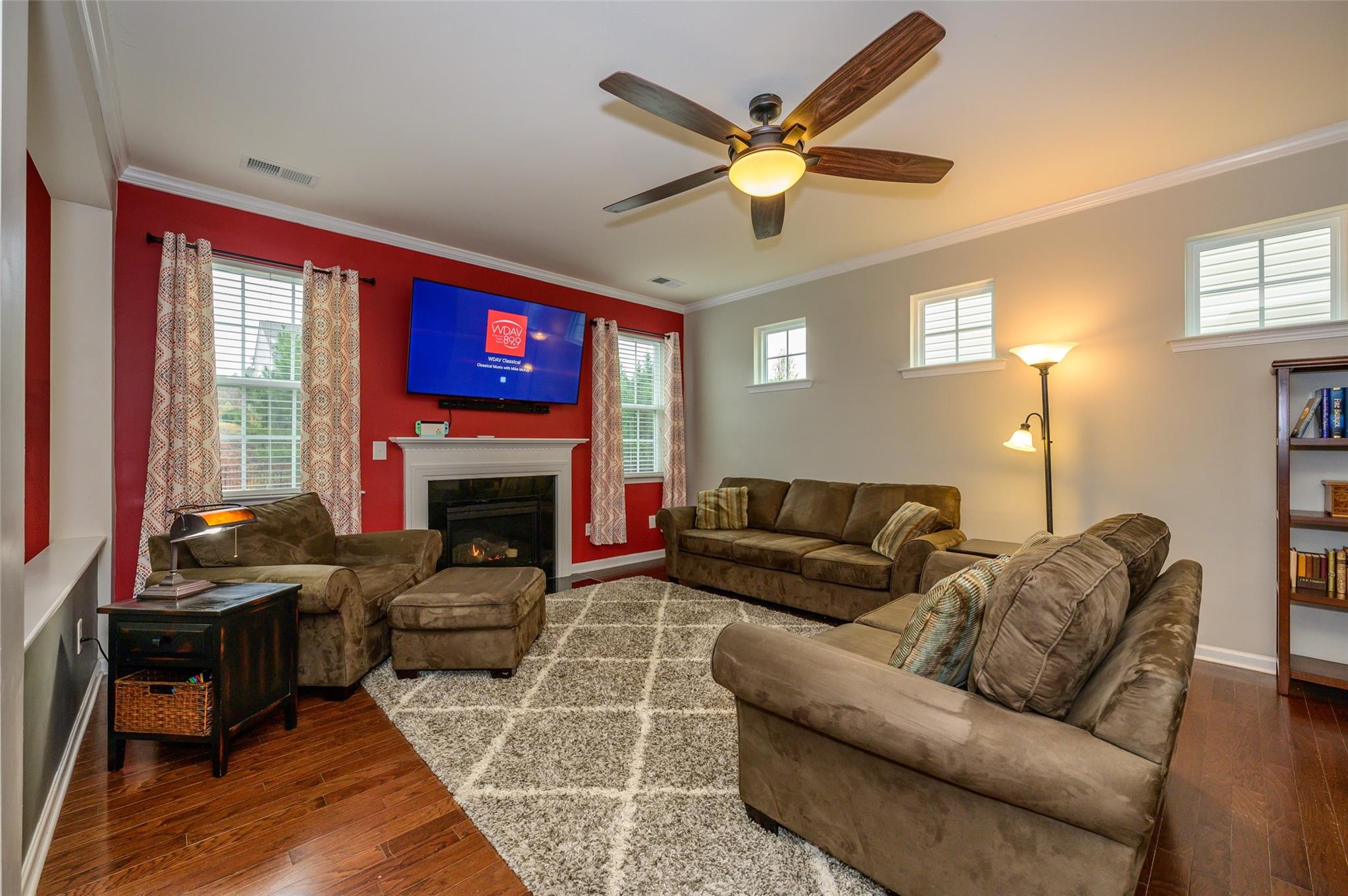 78119 Rillstone Drive Lancaster, SC 29720 - Photo 8 of 31 a living room with furniture a fireplace and a flat screen tv