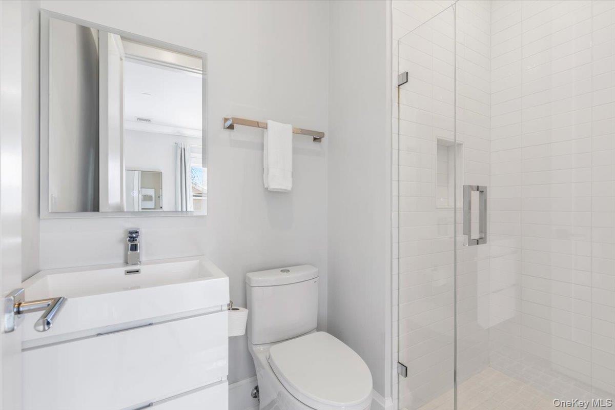 100 Dearborn Avenue Rye, NY 10580 - Photo 25 of 49 a bathroom with a toilet sink vanity and mirror