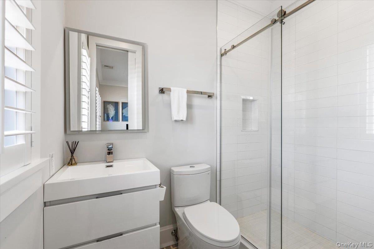 100 Dearborn Avenue Rye, NY 10580 - Photo 27 of 49 a bathroom with a toilet sink vanity and shower