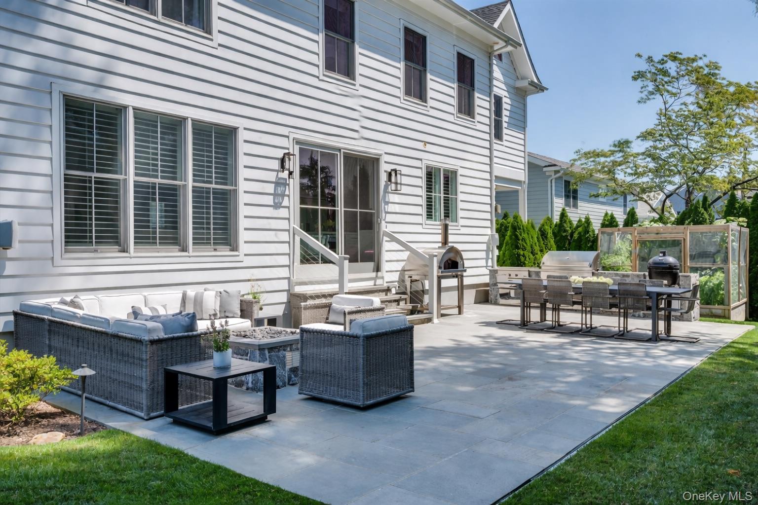 100 Dearborn Avenue Rye, NY 10580 - Photo 36 of 49 a view of a house with patio and a yard