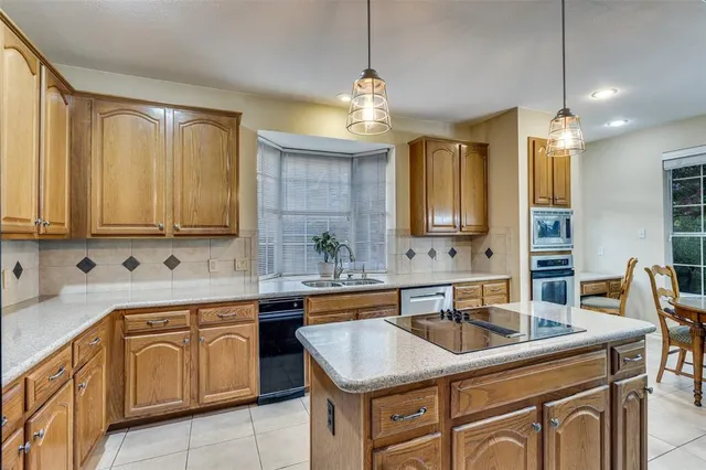 a kitchen that has a sink and a stove in it