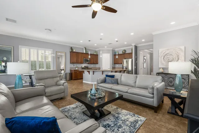 a living room with furniture kitchen view and a fireplace