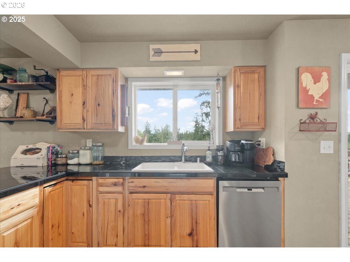 1415 Sightly Road Toutle, WA 98649 - Photo 11 of 36 a kitchen with granite countertop a sink and a white cabinets