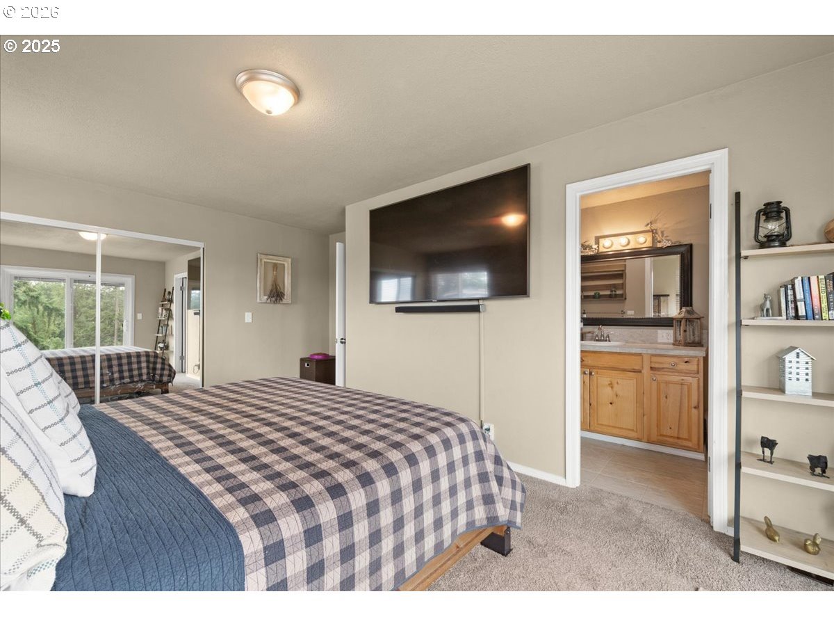 1415 Sightly Road Toutle, WA 98649 - Photo 13 of 36 a bedroom with a bed and a flat screen tv