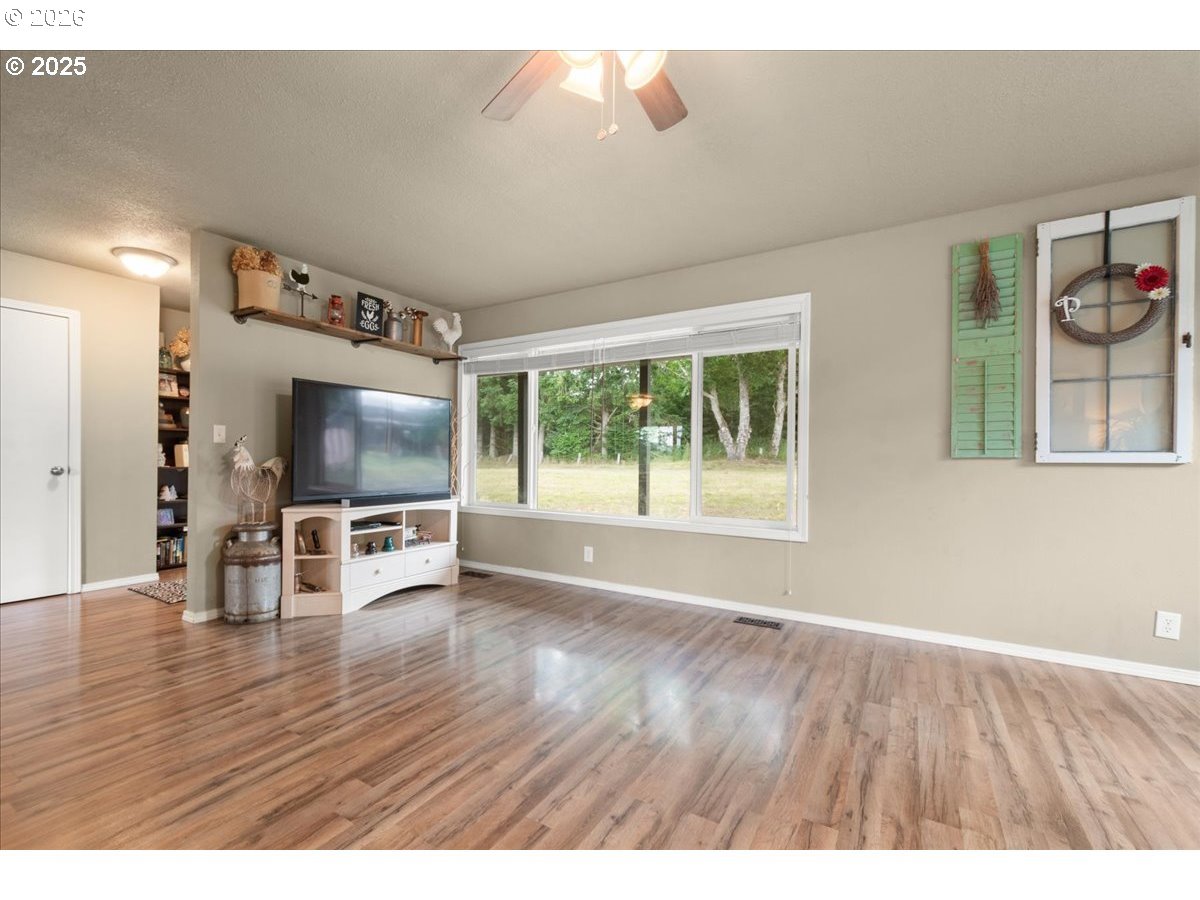 1415 Sightly Road Toutle, WA 98649 - Photo 14 of 36 a view of livingroom with furniture flat screen tv and floor to ceiling window