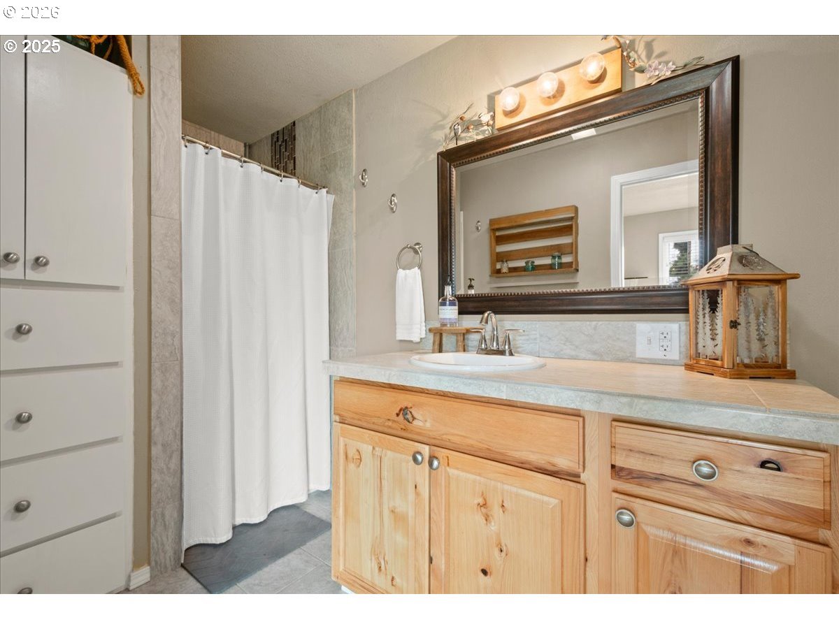 1415 Sightly Road Toutle, WA 98649 - Photo 15 of 36 a bathroom with a sink vanity and a mirror