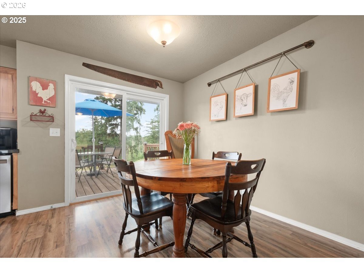 1415 Sightly Road Toutle, WA 98649 - Photo 17 of 36 a view of a dining room with furniture window and wooden floor