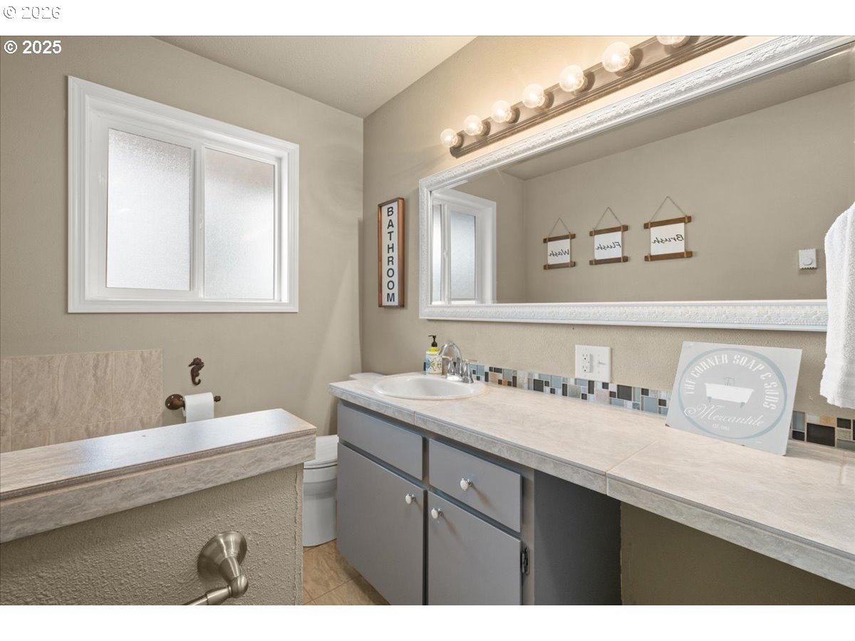 1415 Sightly Road Toutle, WA 98649 - Photo 20 of 36 a bathroom with a sink and a mirror