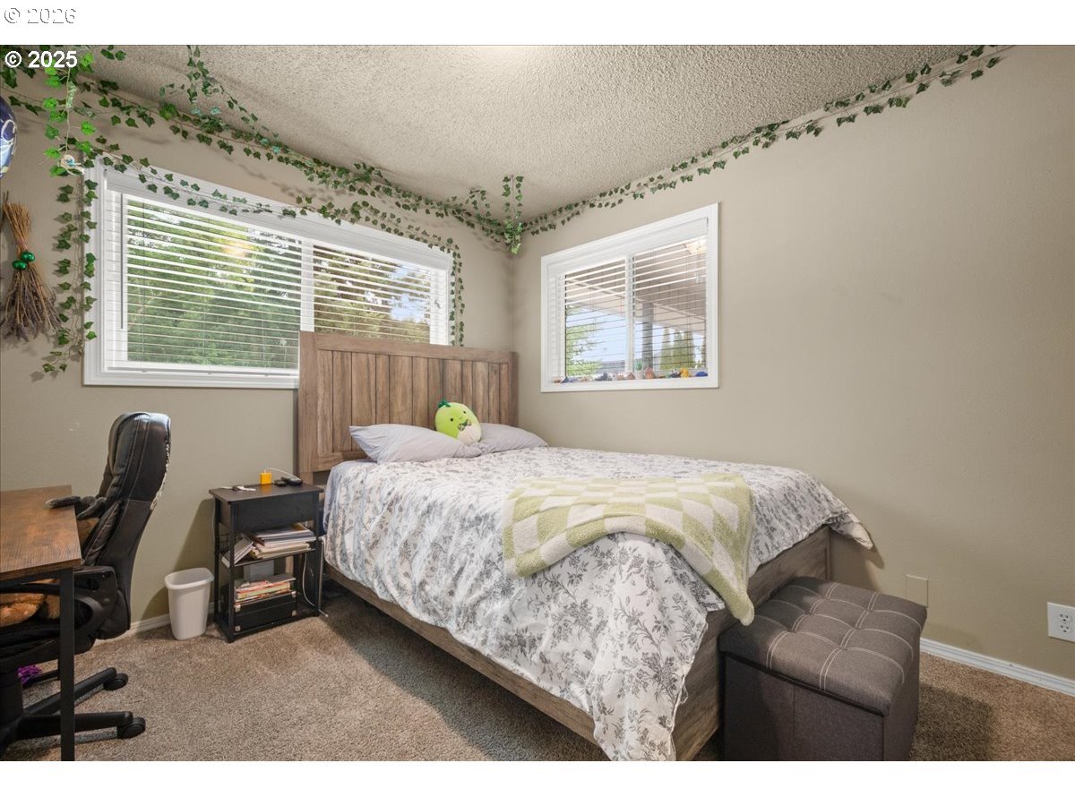1415 Sightly Road Toutle, WA 98649 - Photo 21 of 36 a bed sitting in a bedroom next to a window