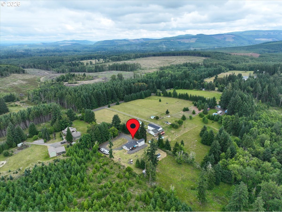 1415 Sightly Road Toutle, WA 98649 - Photo 33 of 36 a view of a houses with a lush green forest