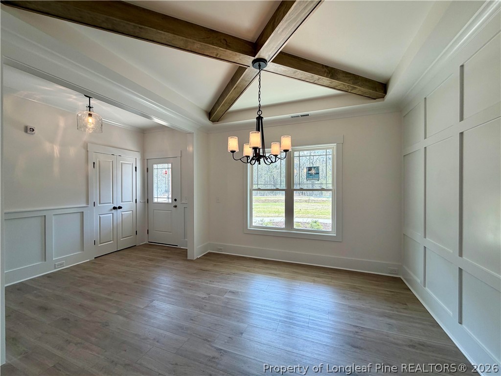1788 Alderman Mill Road Dunn, NC 28334 - Photo 4 of 14 a view of an empty room with wooden floor and a window