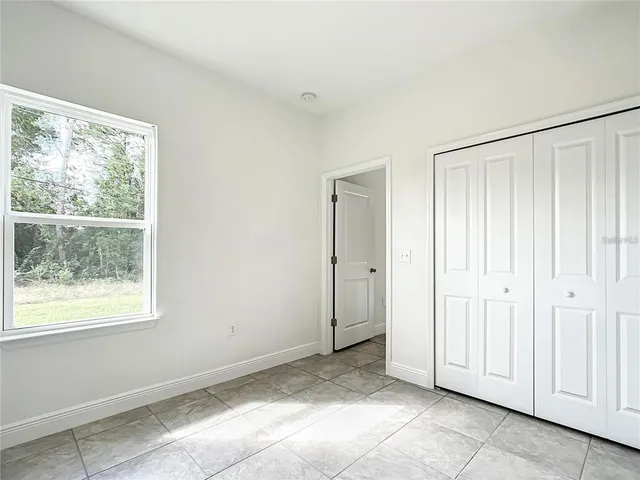 a bathroom with a granite countertop sink toilet mirror and bathtub