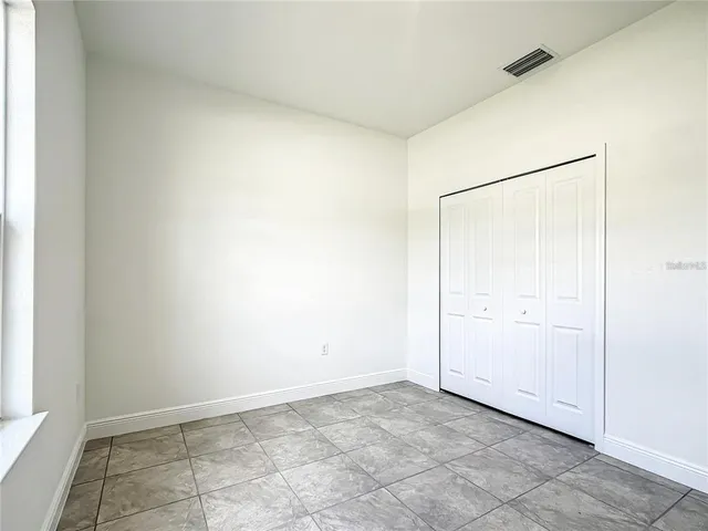 an aerial view of a house with a garden and lake view