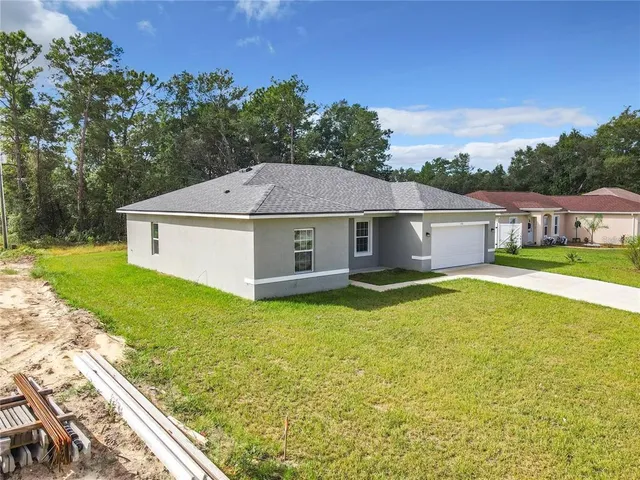 an aerial view of house with yard swimming pool and outdoor seating