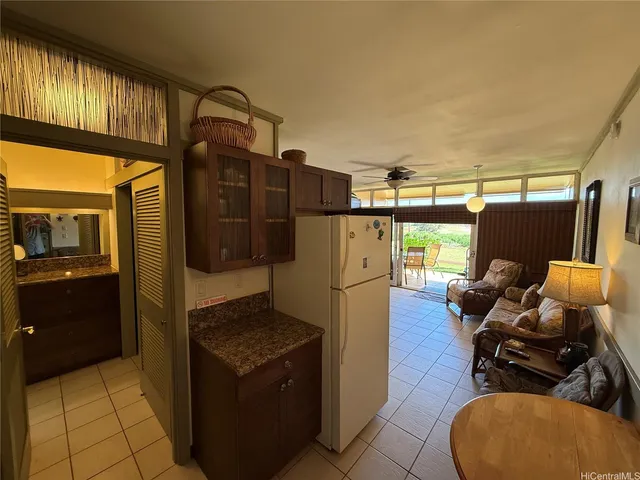 a view of a patio with table and chairs potted plants and a large tree