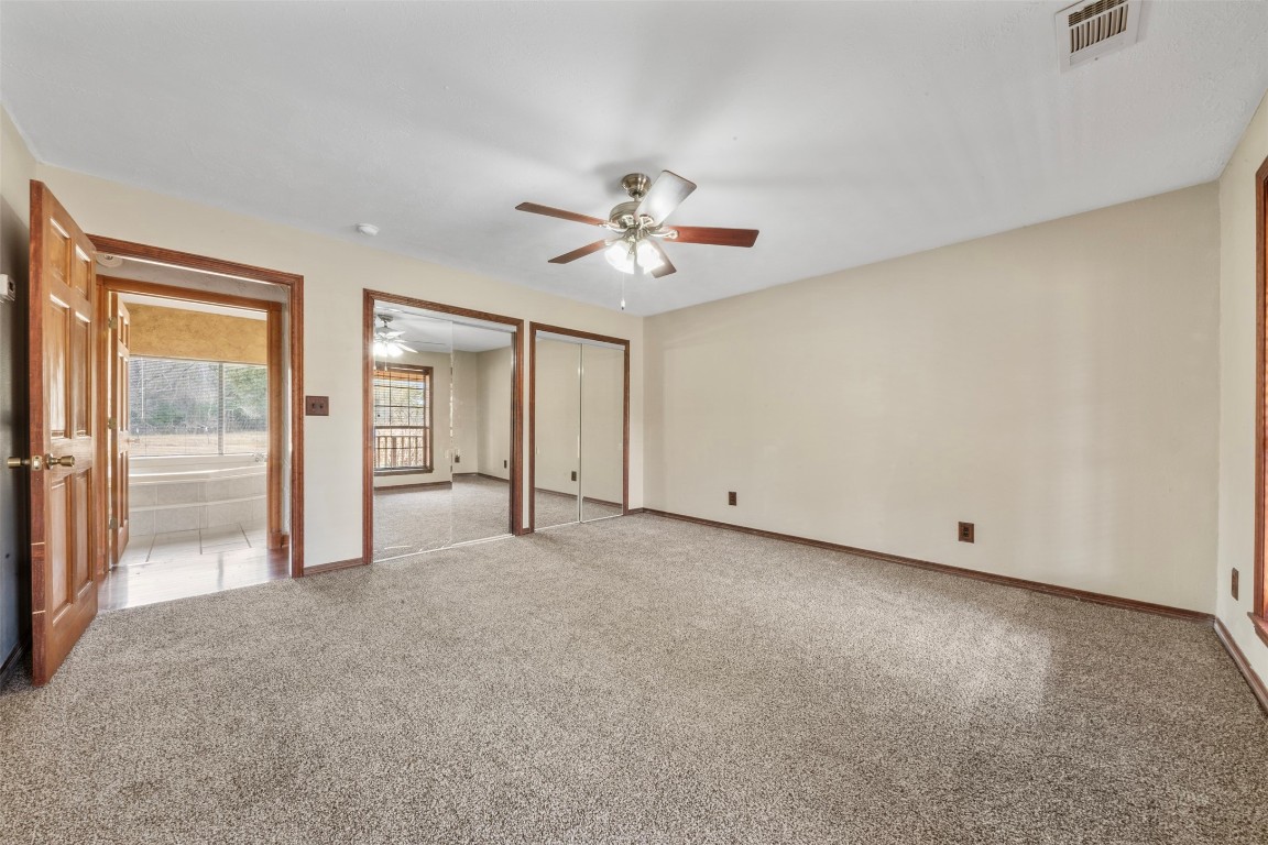 33349 Interstate 10 Hankamer, TX 77560 - Photo 12 of 28 an empty room with chandelier fan and windows