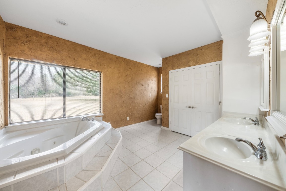 33349 Interstate 10 Hankamer, TX 77560 - Photo 14 of 28 a spacious bedroom with a bed and a large window