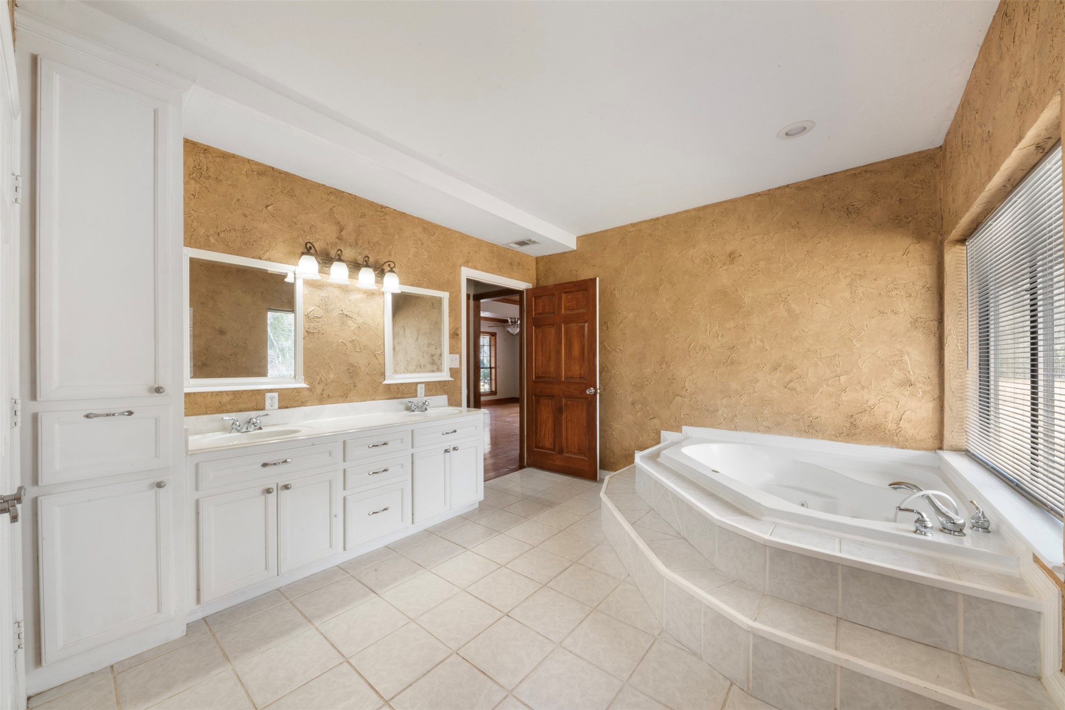 33349 Interstate 10 Hankamer, TX 77560 - Photo 15 of 28 a spacious bathroom with a bathtub sink and mirror