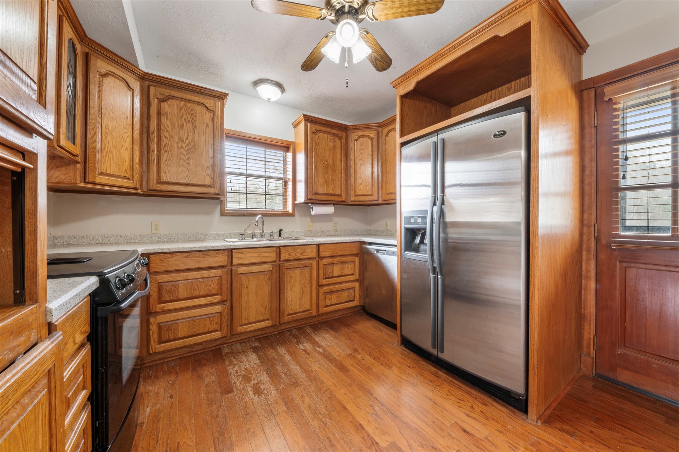 33349 Interstate 10 Hankamer, TX 77560 - Photo 8 of 28 a kitchen with stainless steel appliances granite countertop a refrigerator a sink dishwasher a stove and white countertops with wooden floor