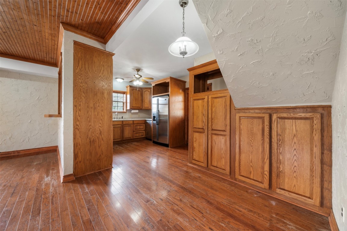 33349 Interstate 10 Hankamer, TX 77560 - Photo 10 of 28 an empty room with wooden floor cabinet and windows