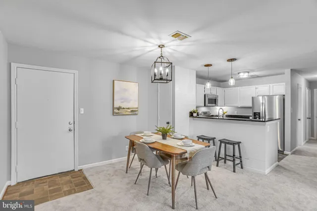 a view of a dining room with furniture and chandelier