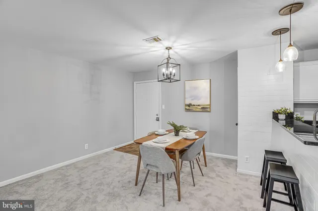a dining room with a table and chairs
