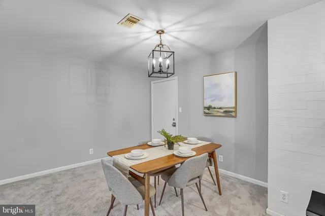 a dining room with a table and chairs