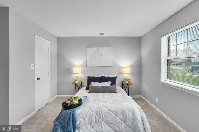 a bedroom with a bed and window