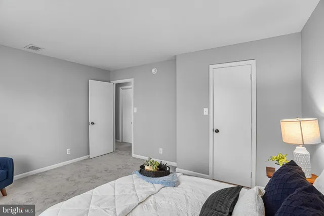 a bedroom with a bed and a lamp